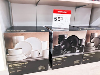 dinnerware sets in their box next to a 55% off sign