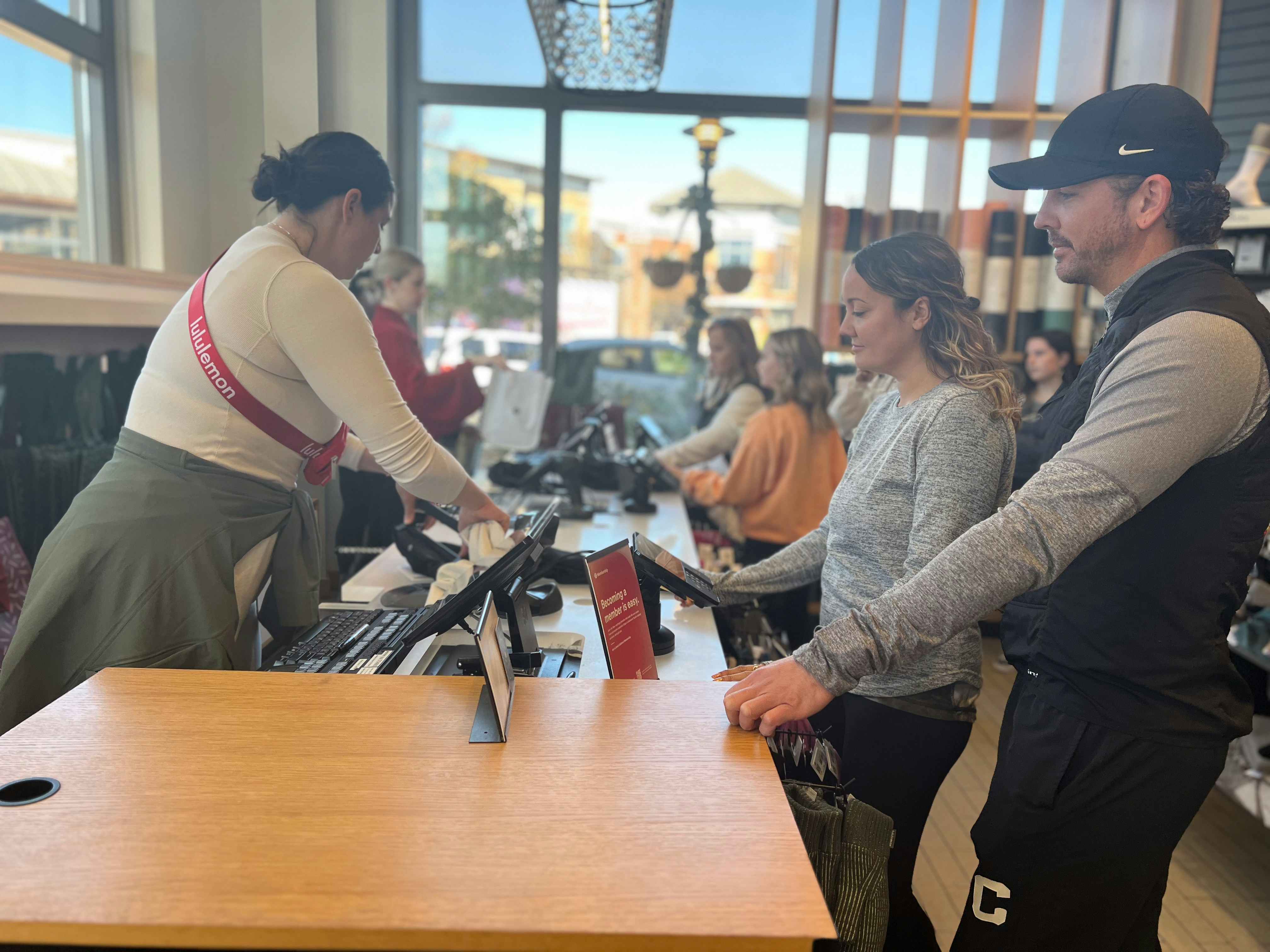 Two people checking out at cash register at lululemon