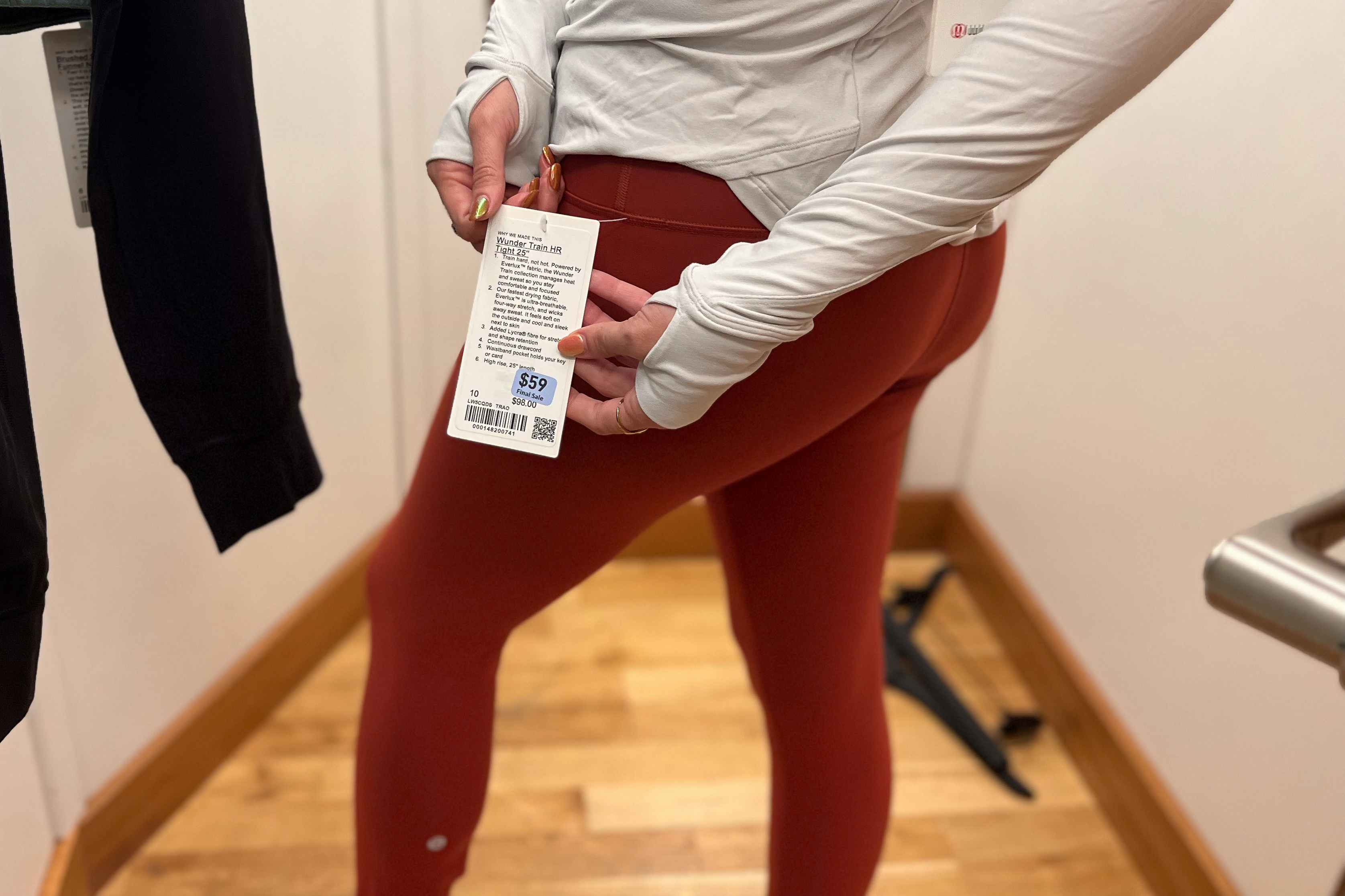 model trying on leggings showing the price tag