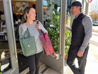 couple outside lululemon store holding bags