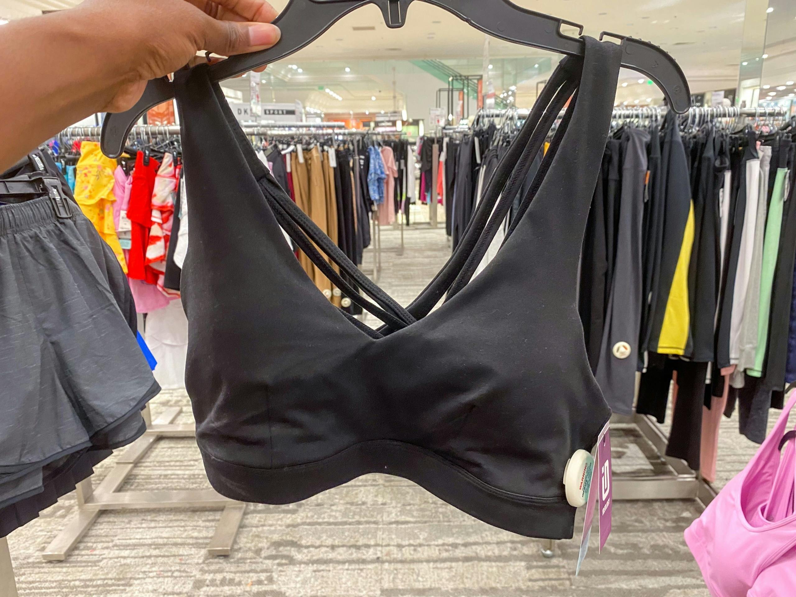 hand holding black id low impact sports bra