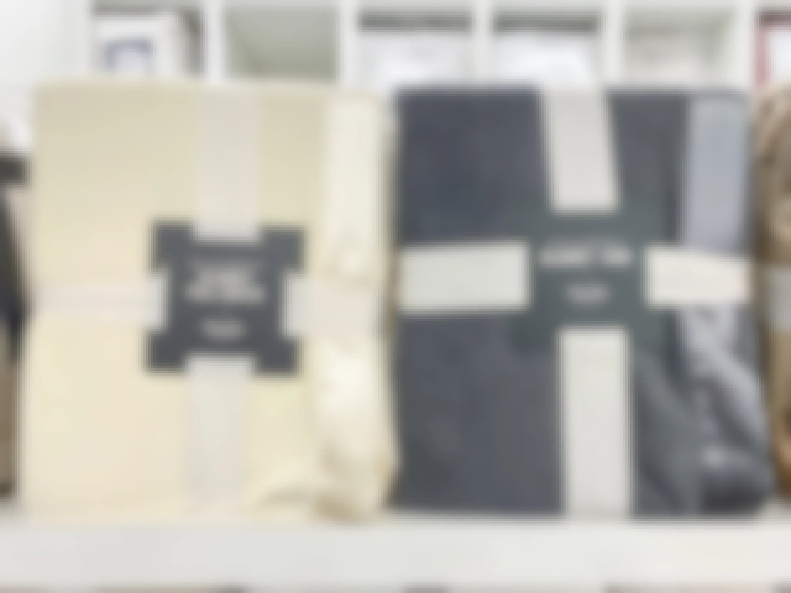 Martha Stewart Fleece blankets in cream and dark grey on a shelf