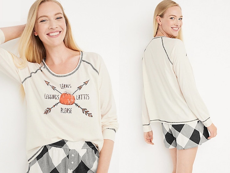 A woman wearing a fall graphic tee and short pajama set