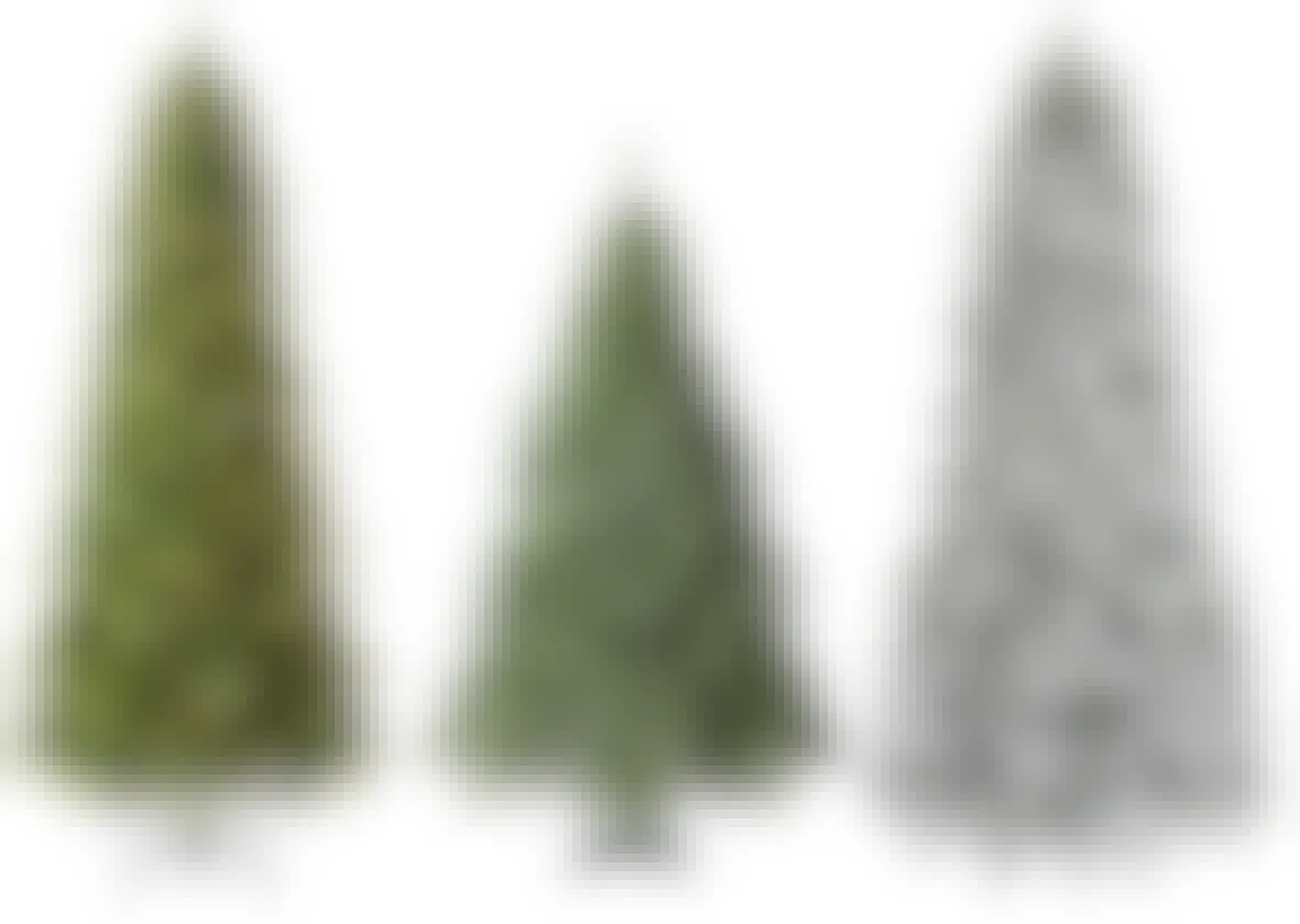 Three articificial Christmas trees from Menards on a white background