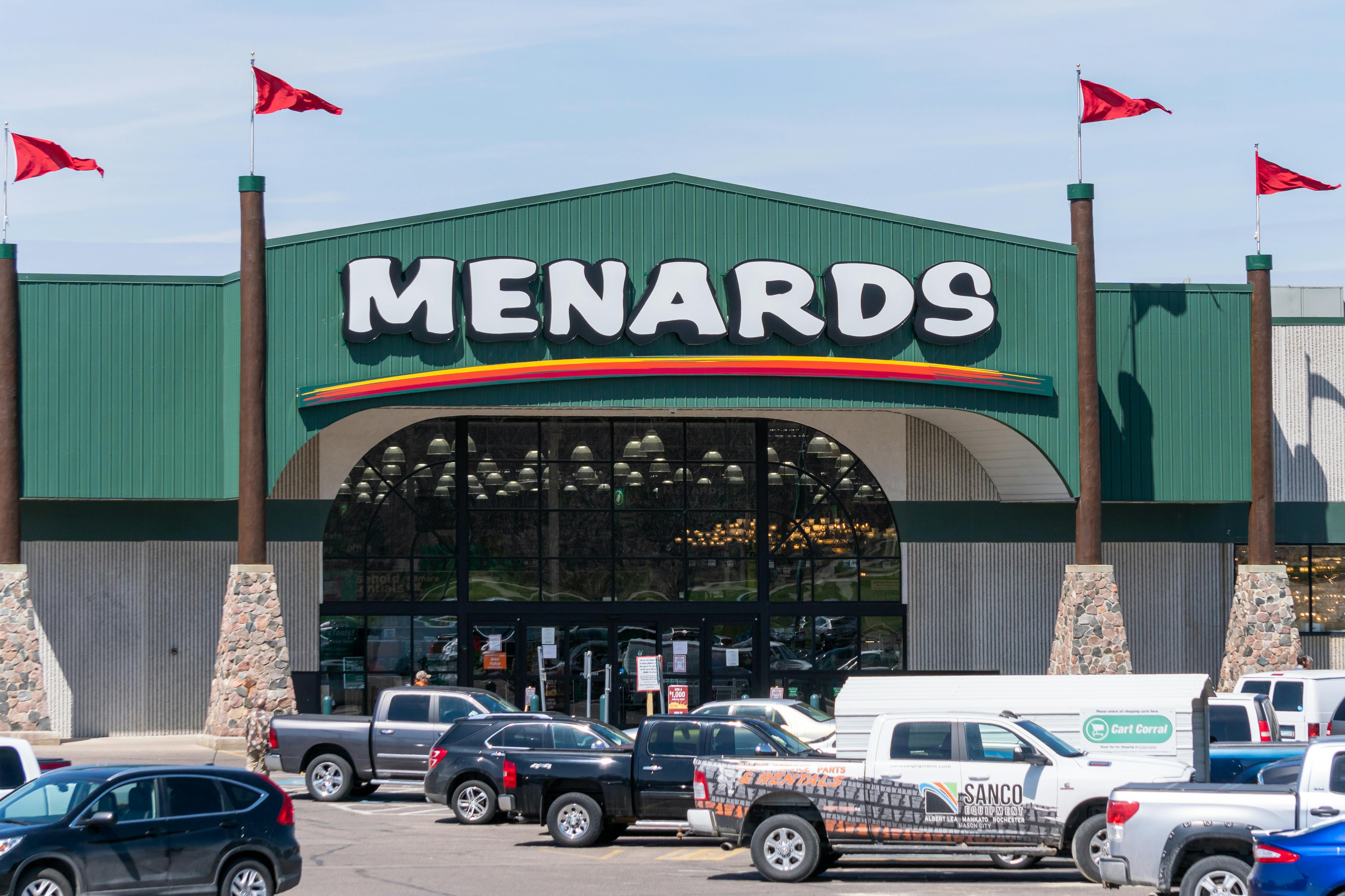 A Menards storefront with cars in the parking lot.