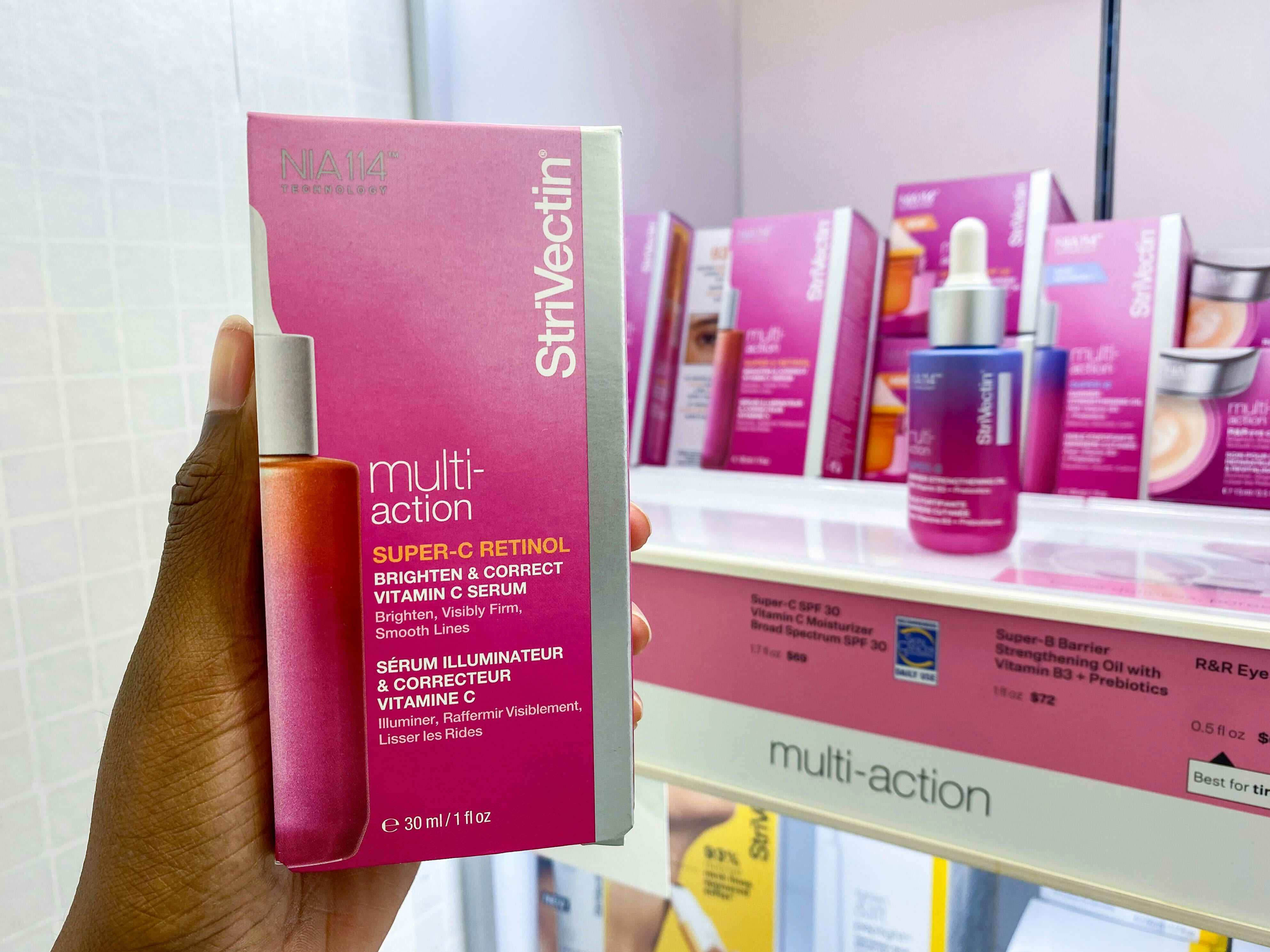 someone holding a pink package of a multi-action retinol from stir vectin