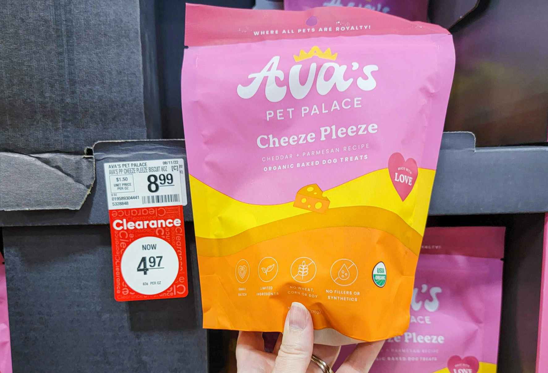 hand holding a bag of ava's pet palace organic dog treats in cheeze please flavor