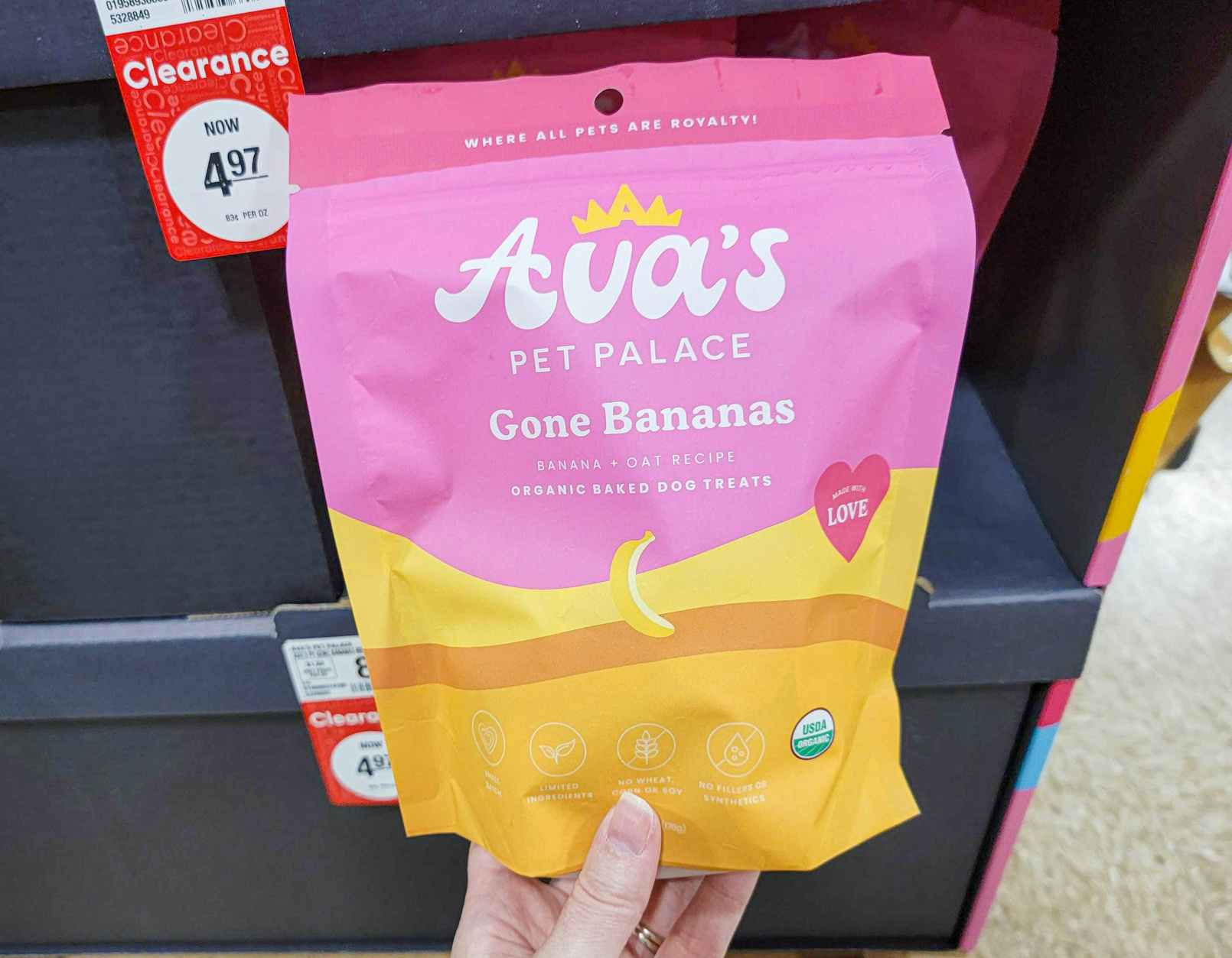 hand holding a bag of ava's pet palace organic dog treats in gone bananas flavor