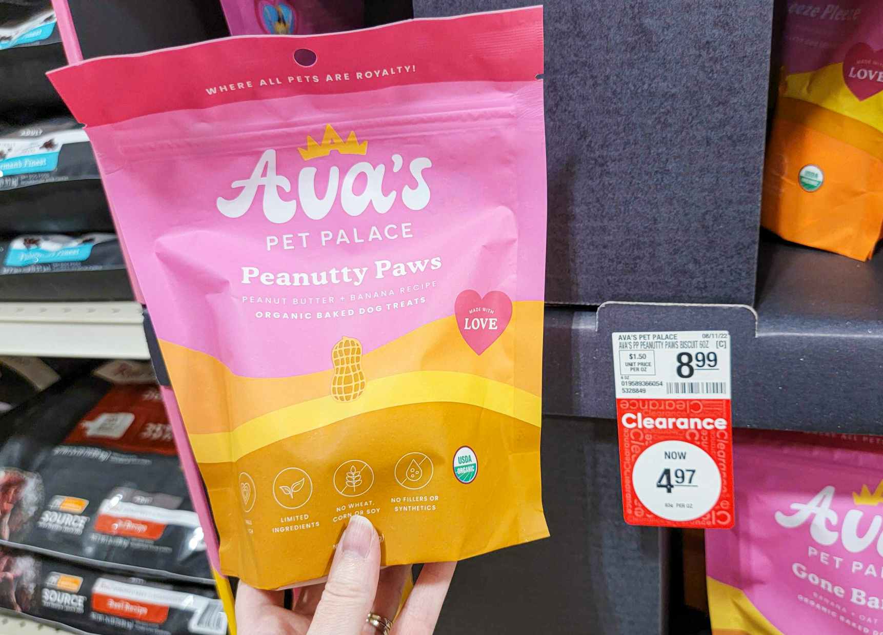 hand holding a bag of avas pet palace peanutty paws dog treats