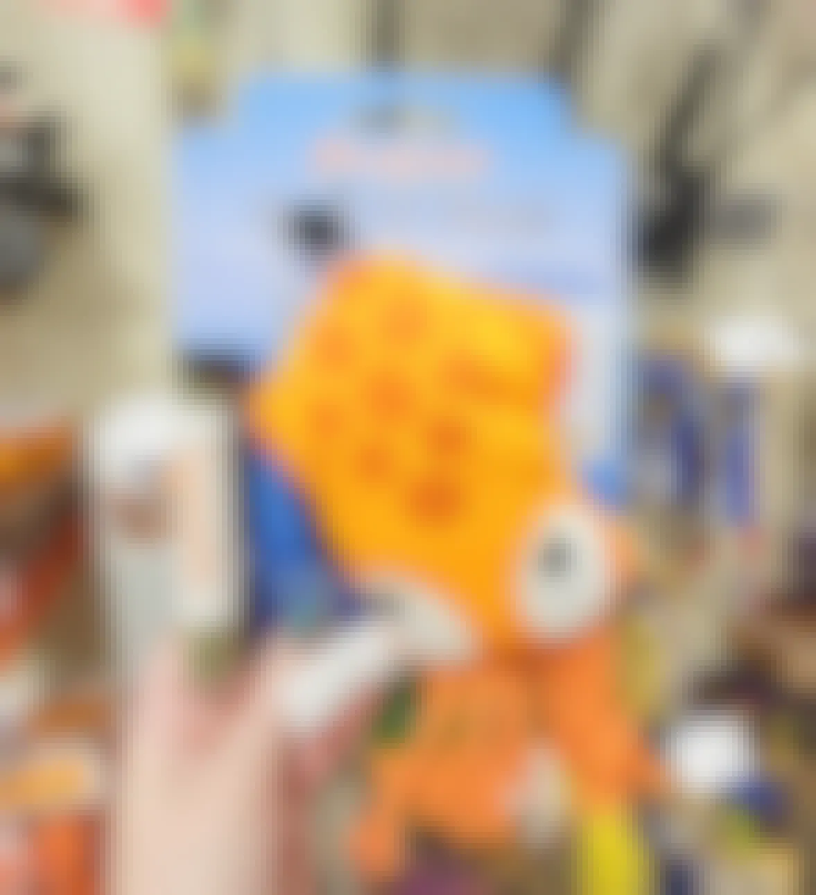 hand holding a catnip orange octopus toy