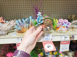 hand holding a small coral aquarium decor piece