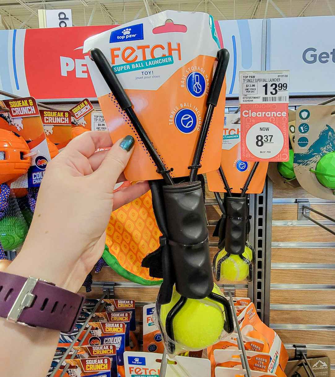 hand holding a fetch ball launcher dog toy