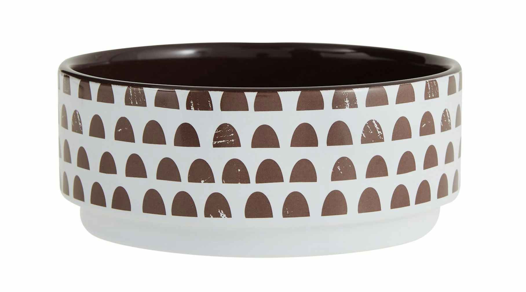 dog food bowl that is white with brown half moons on it