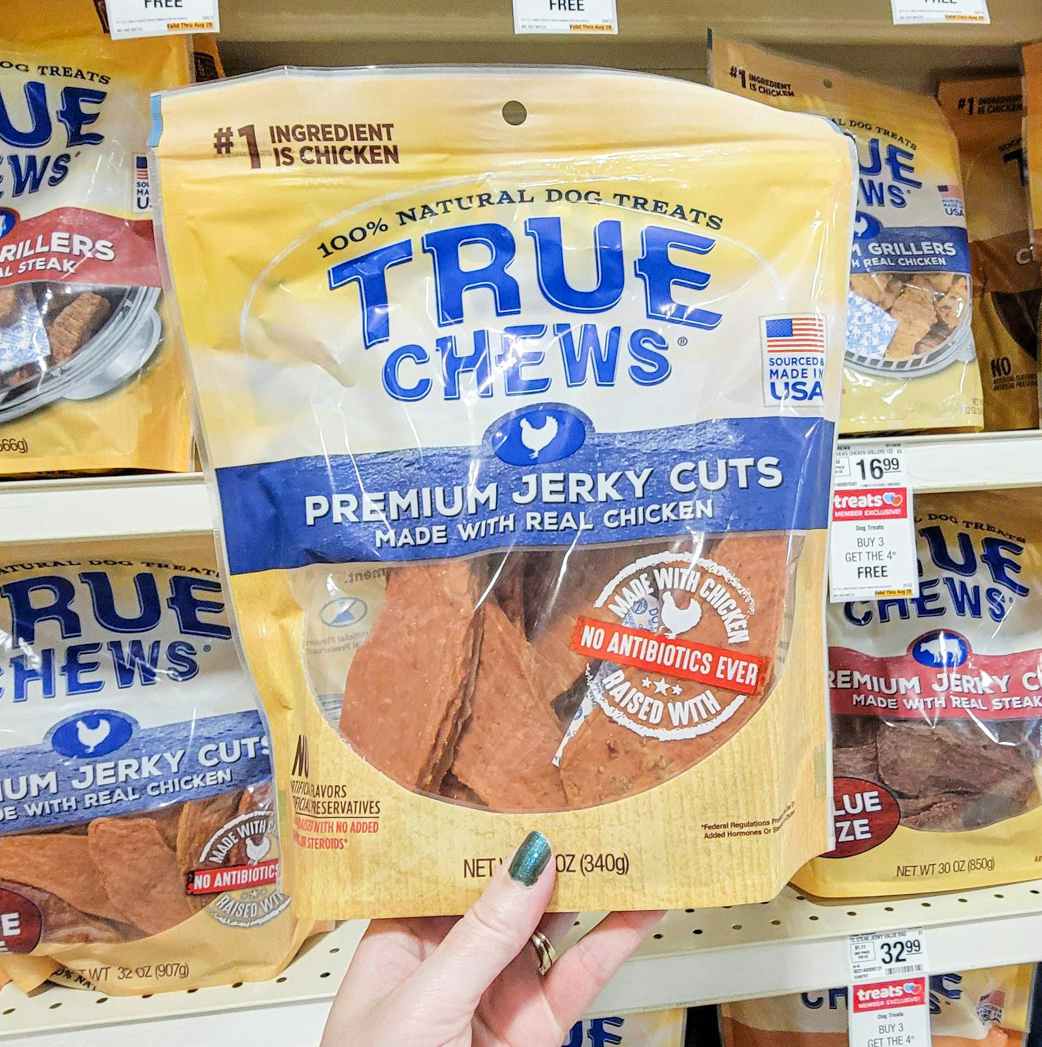 hand holding a bag of true chews dog jerky treats