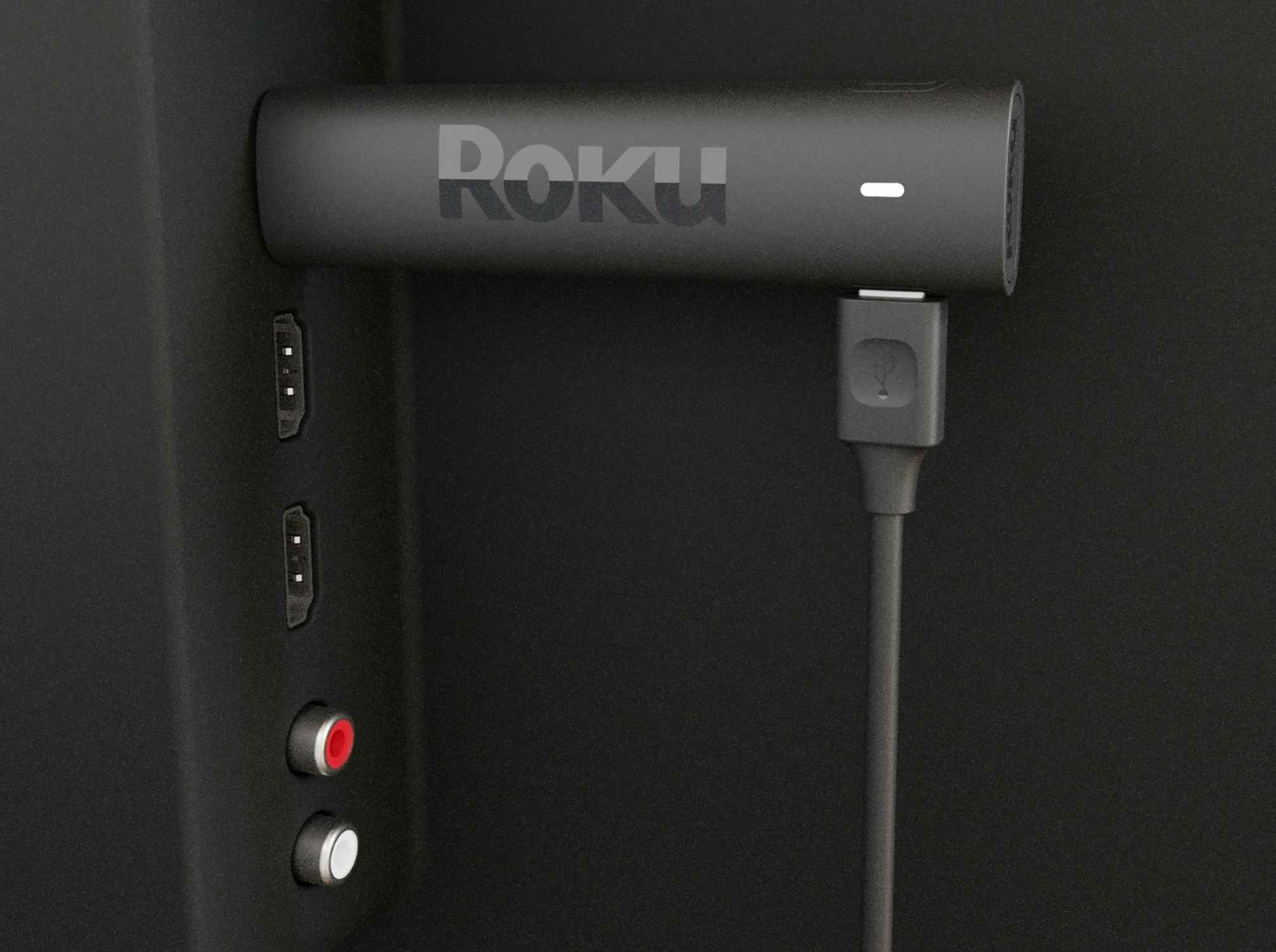 Roku streaming stick plugged into back of TV