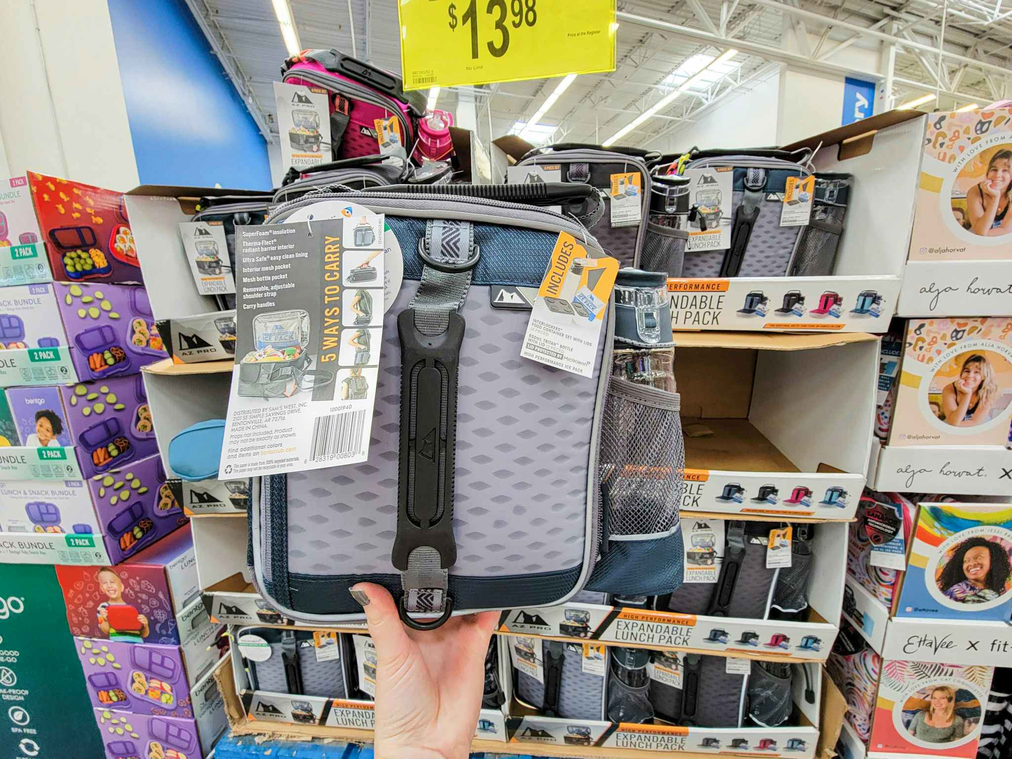 hand holding a grey lunch box