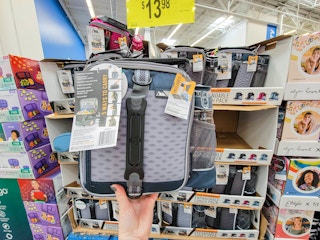 hand holding a grey lunch box