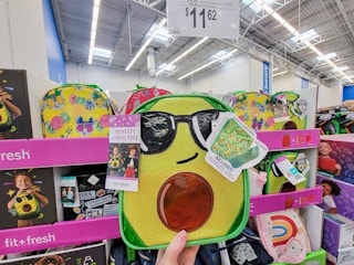 hand holding an avocado lunch bag