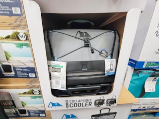 a grey collapsible rolling cooler in a display box