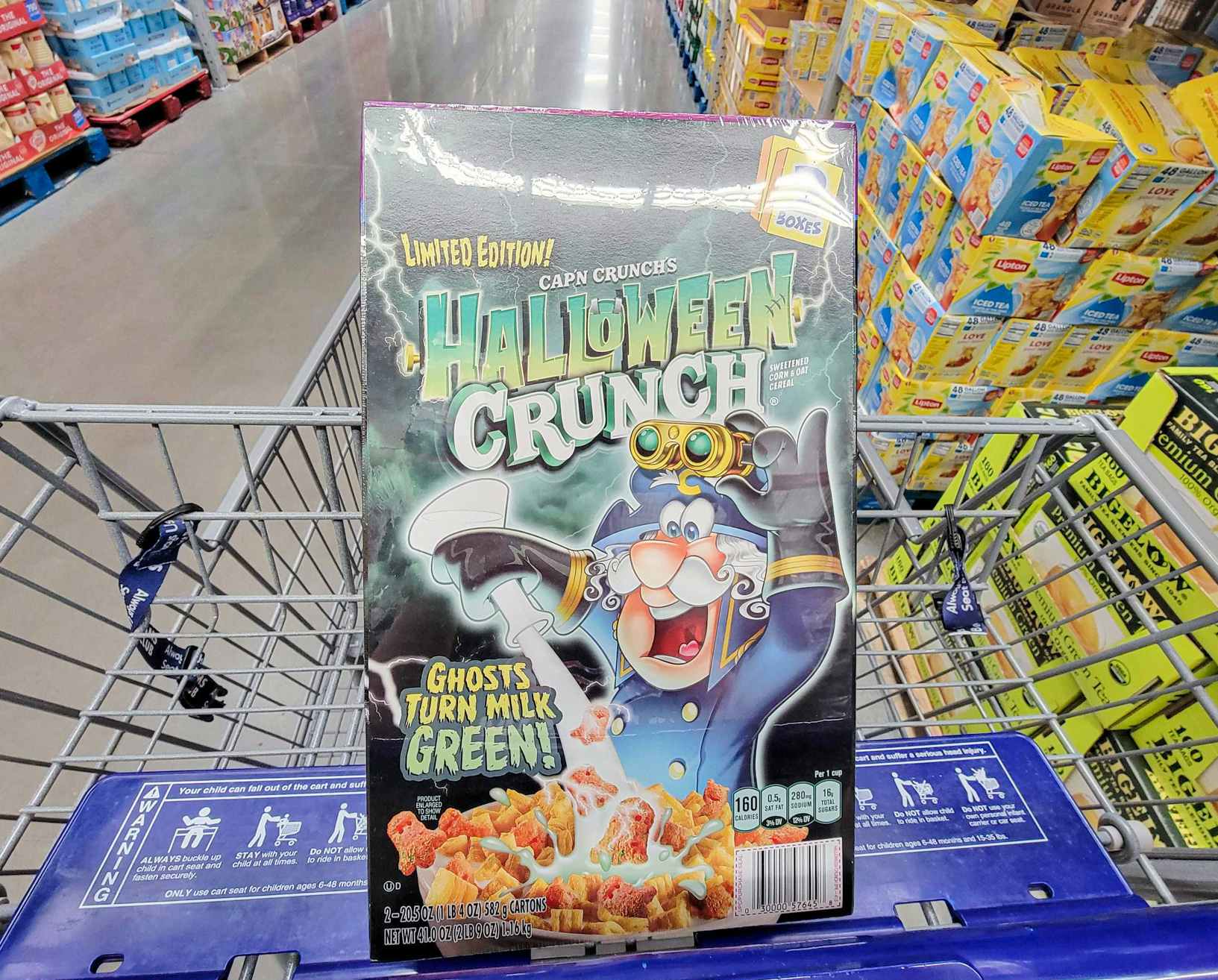 box of halloween themed captain crunch cereal in a cart