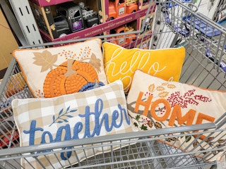 fall themed throw pillows in a cart