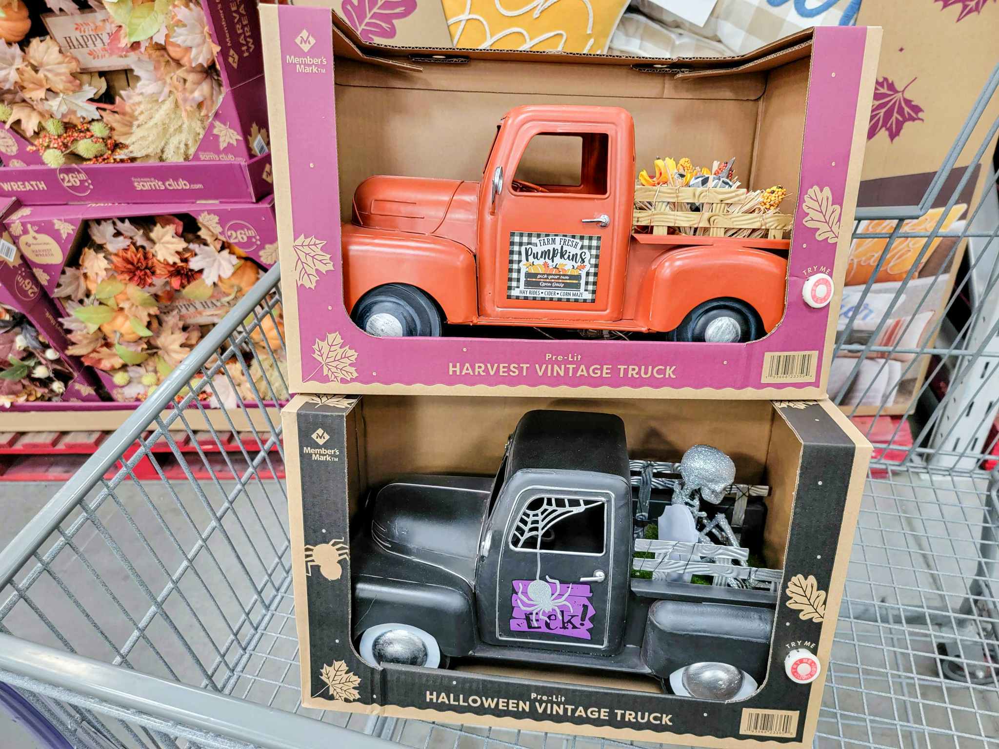fall and halloween themed decorative pre-lit trucks in a cart