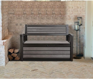 a brown keter storage bench on a patio