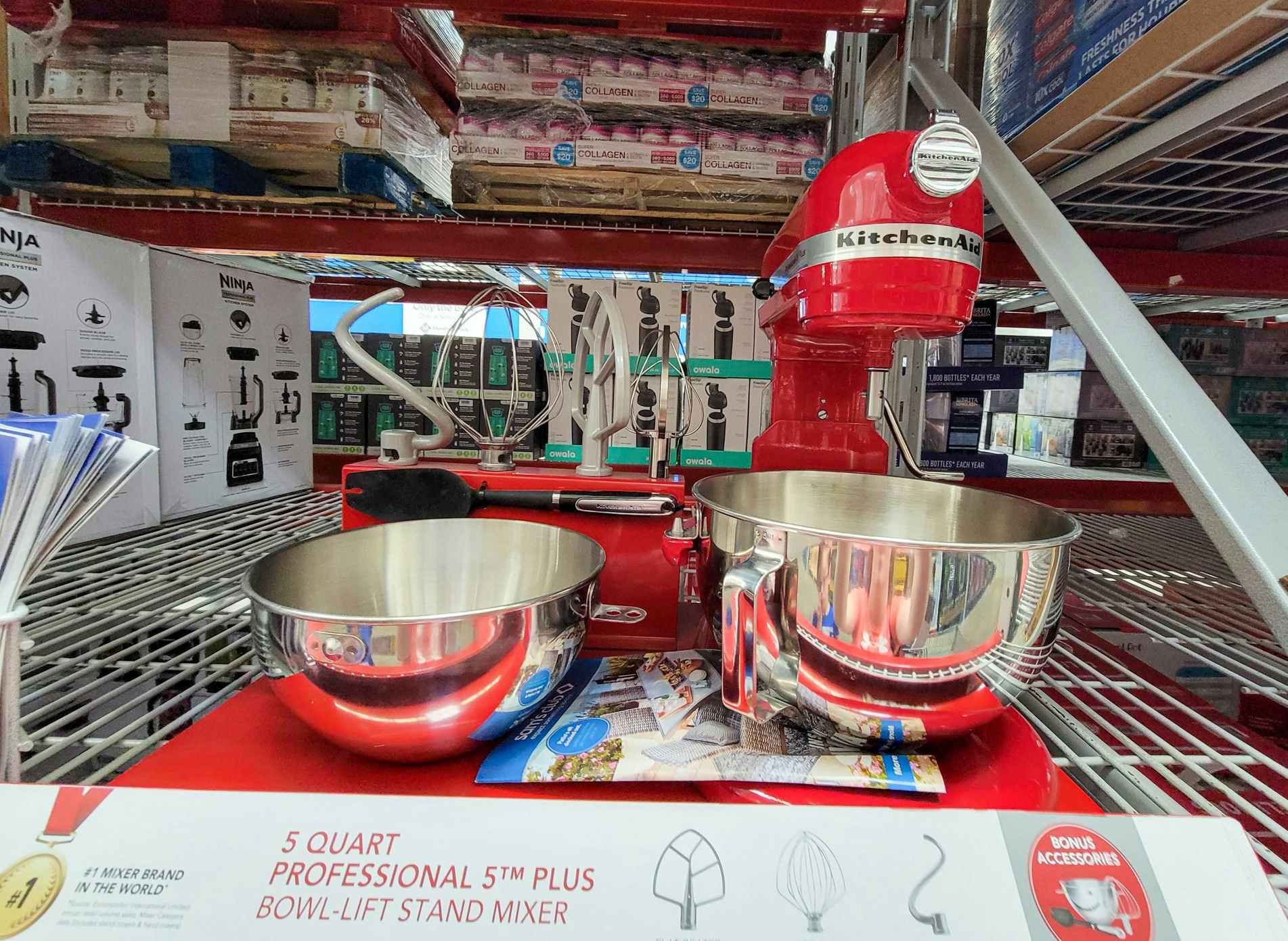 a red kitchenaid pro stand mixer displayed with bonus baker's accessories