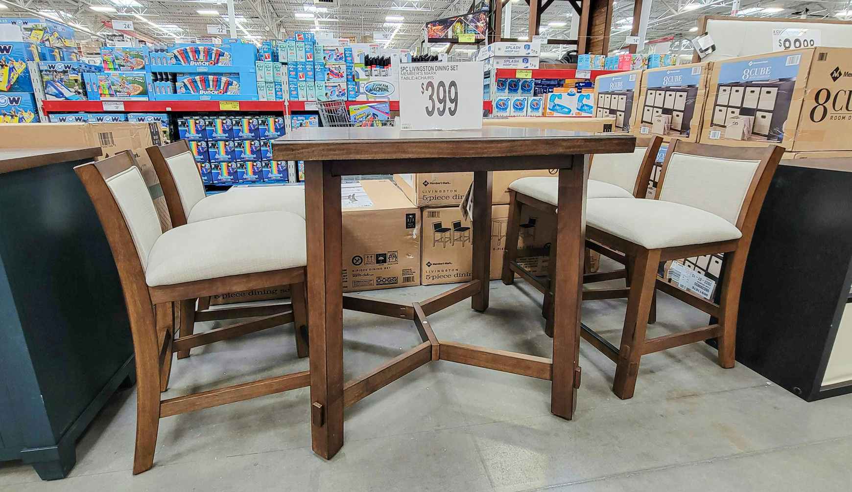 a 5 piece dining set displayed, includes a table and 4 padded chairs