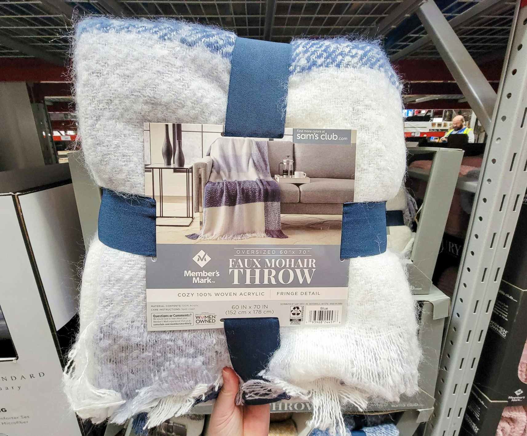 hand holding a white and blue check faux mohair throw blanket