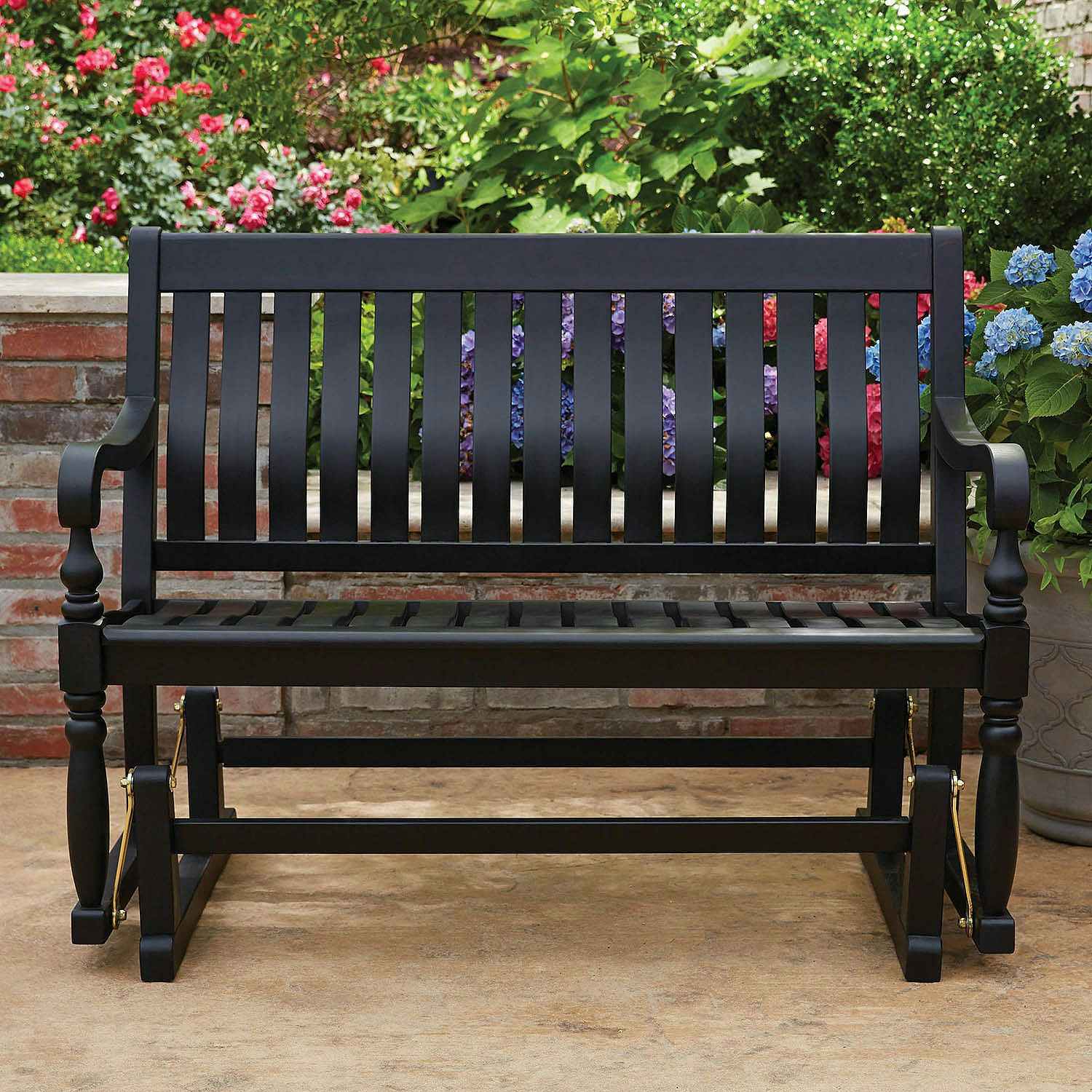 a wooden patio glider bench painted black