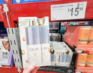 hand holding a 2-pack of olay firming body lotion