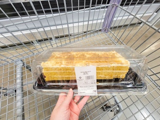 hand holding a pumpkin cookie bar cake in a cart