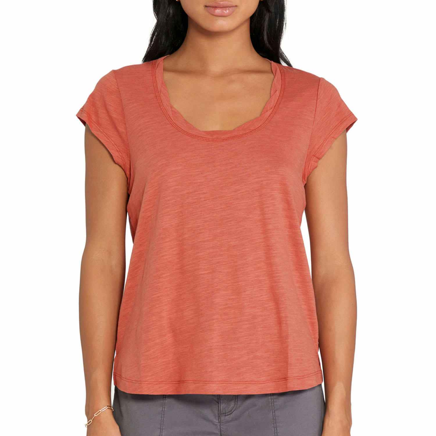 woman wearing a coral colored top