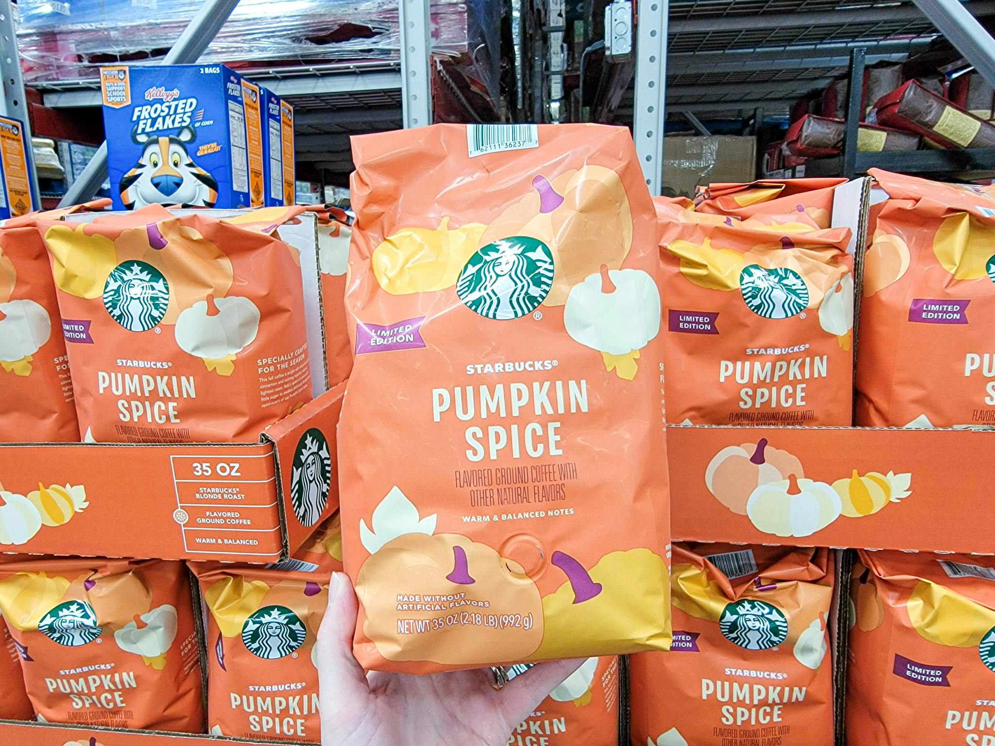 hand holding a bag of starbucks pumpkin spice coffee