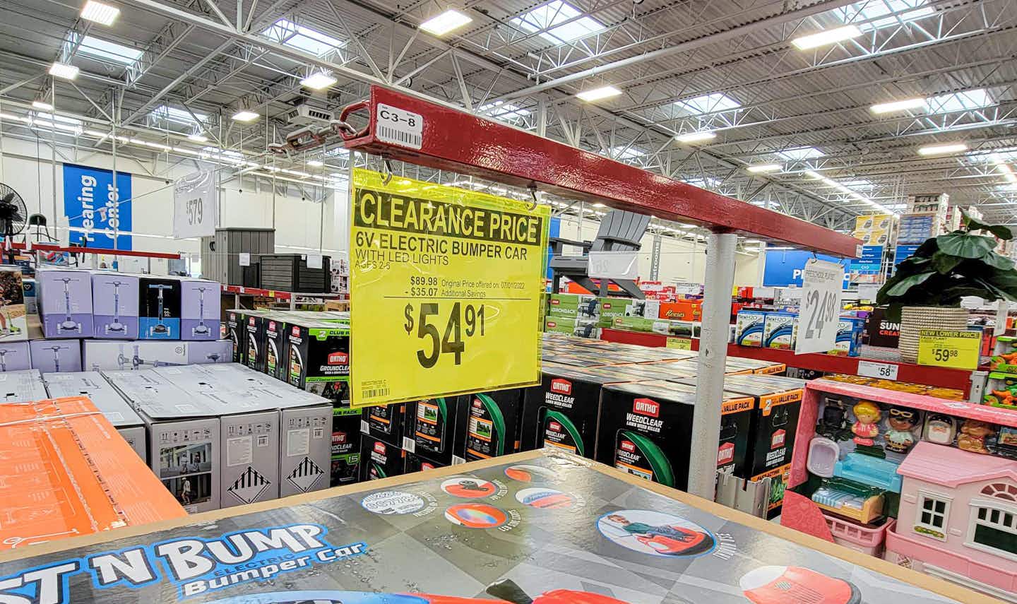 a clearance sign for a red kids bumper car for $54.91