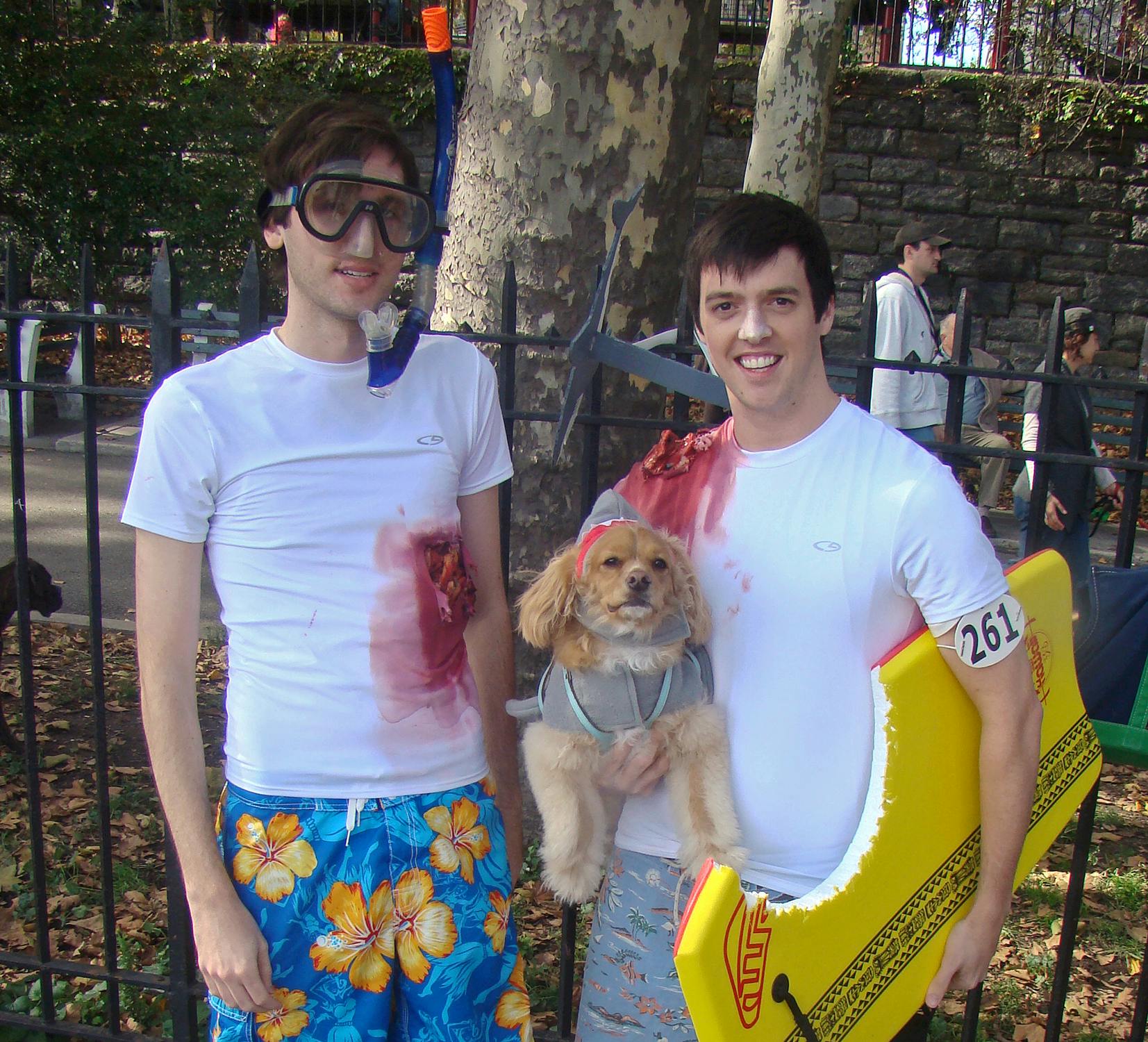 men and dog dressed in shark attack Halloween costumes