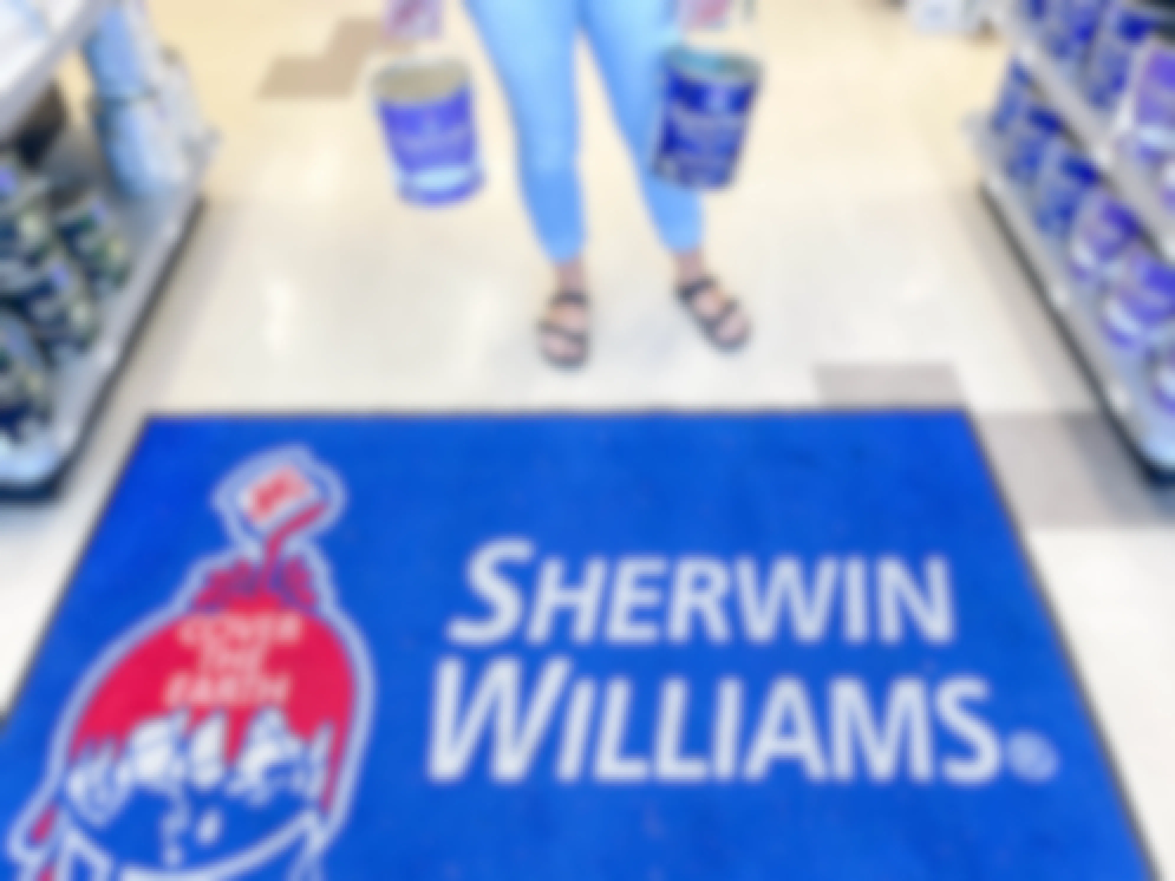 woman holding gallons of paint over a sherwin williams area rug