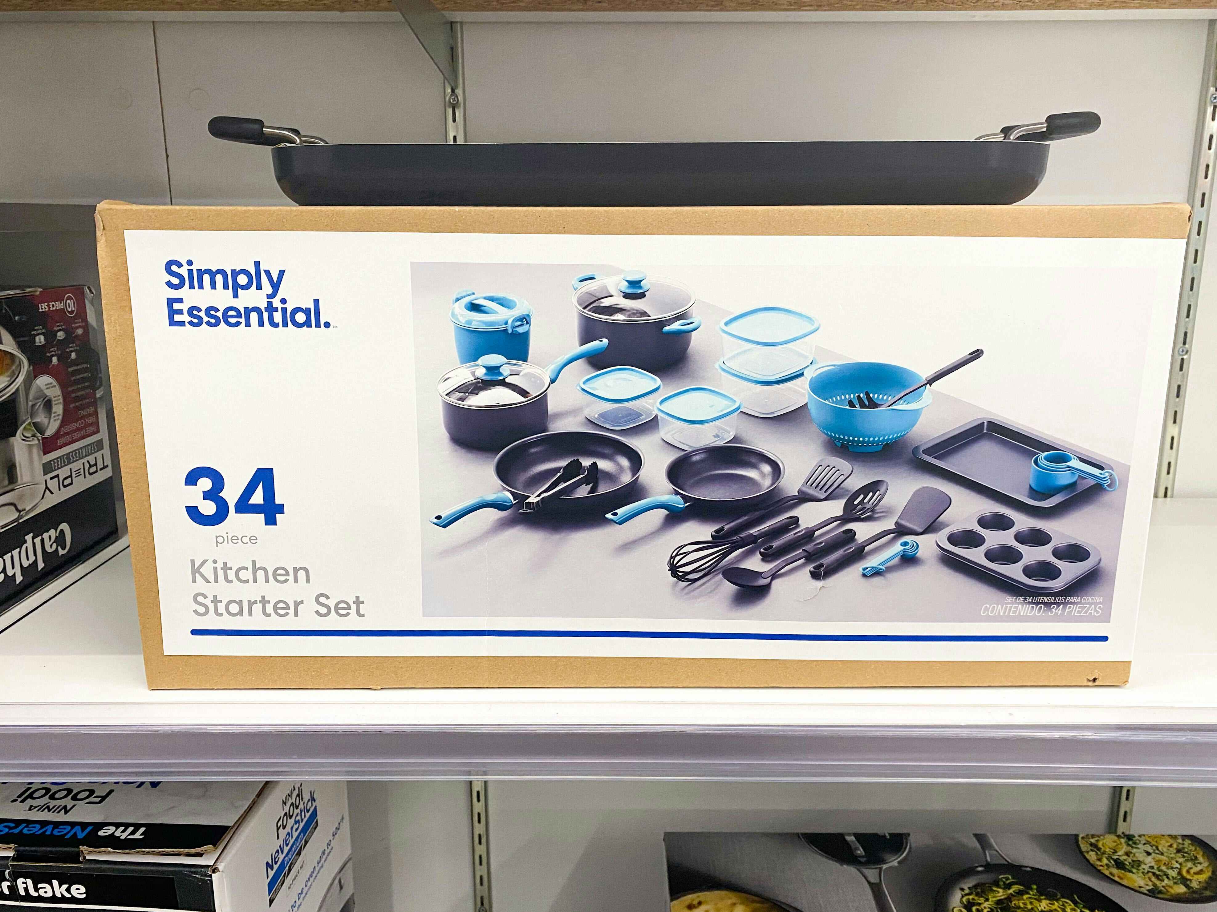 a 34-piece kitchen starter set in its box. contains frying pans, muffin tin, cookie sheet, utensils, etc