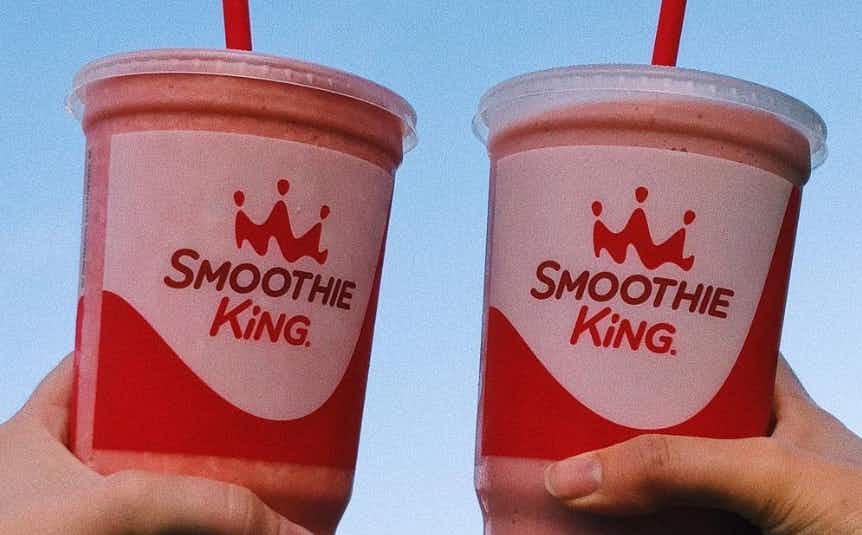 two people holding smoothie king cups. taken from their instagram