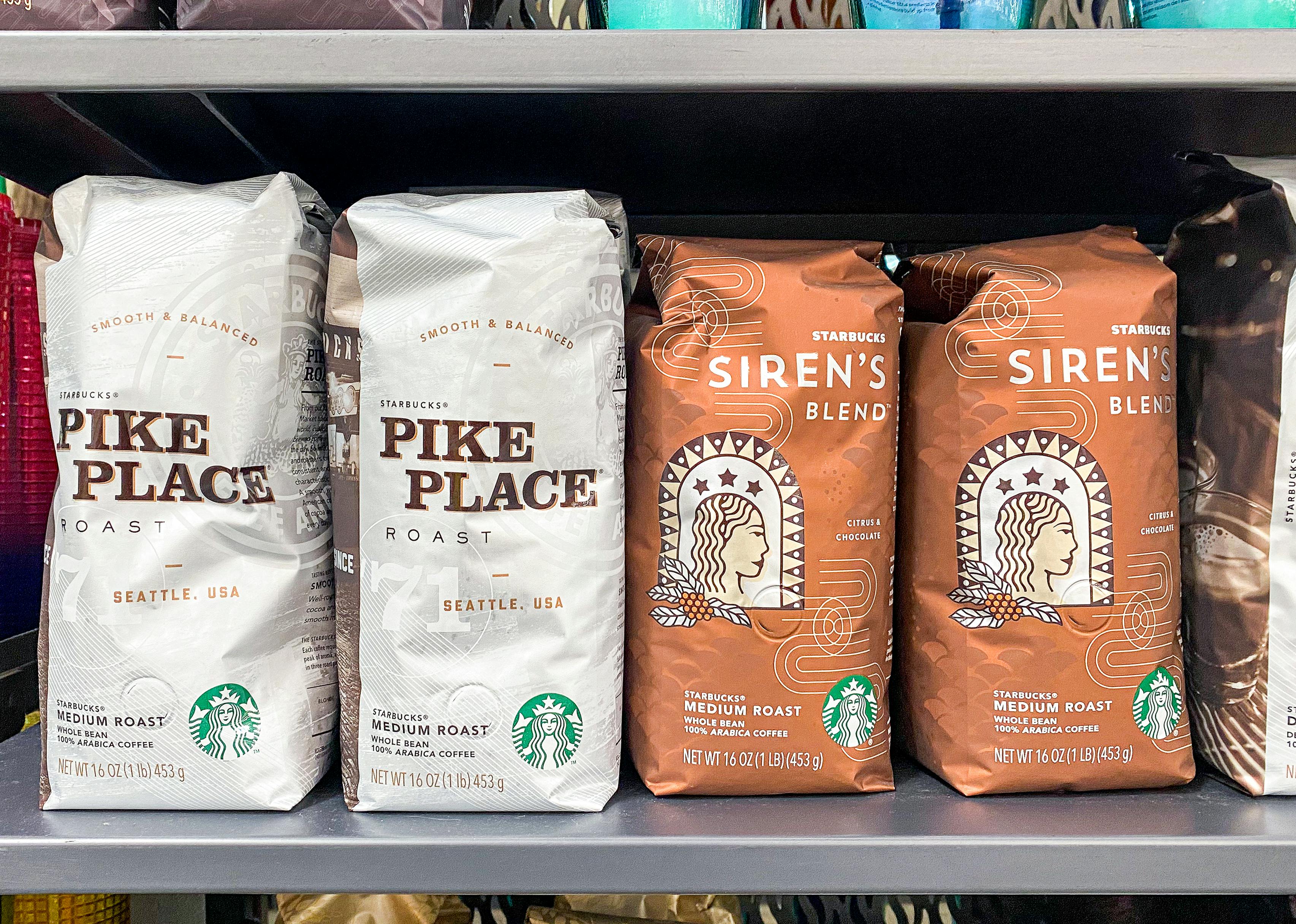 Bags of ground Starbucks coffee on a shelf inside a Starbucks cafe.