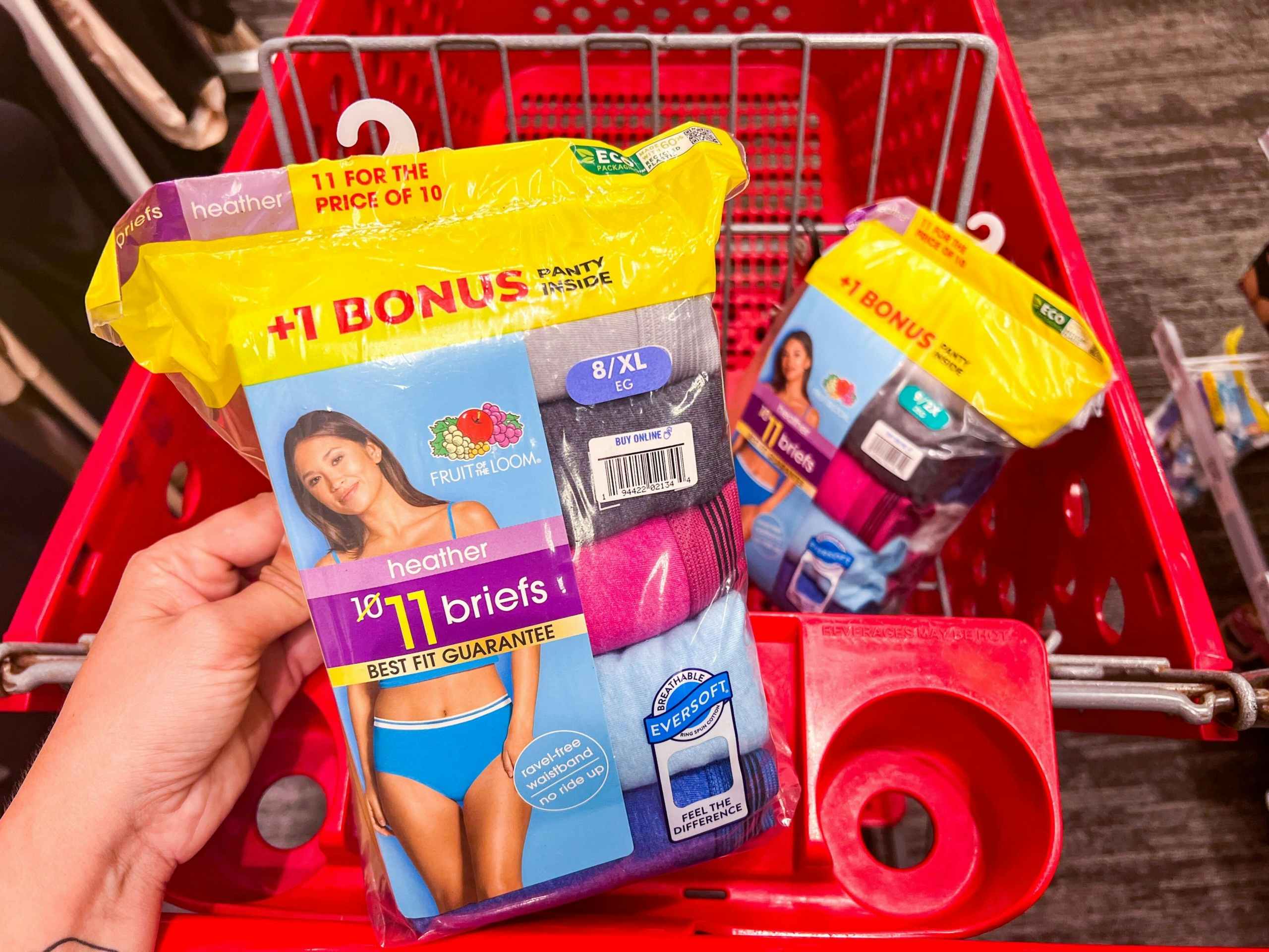 hand holding Fruit of The Loom Underwear above a Target cart