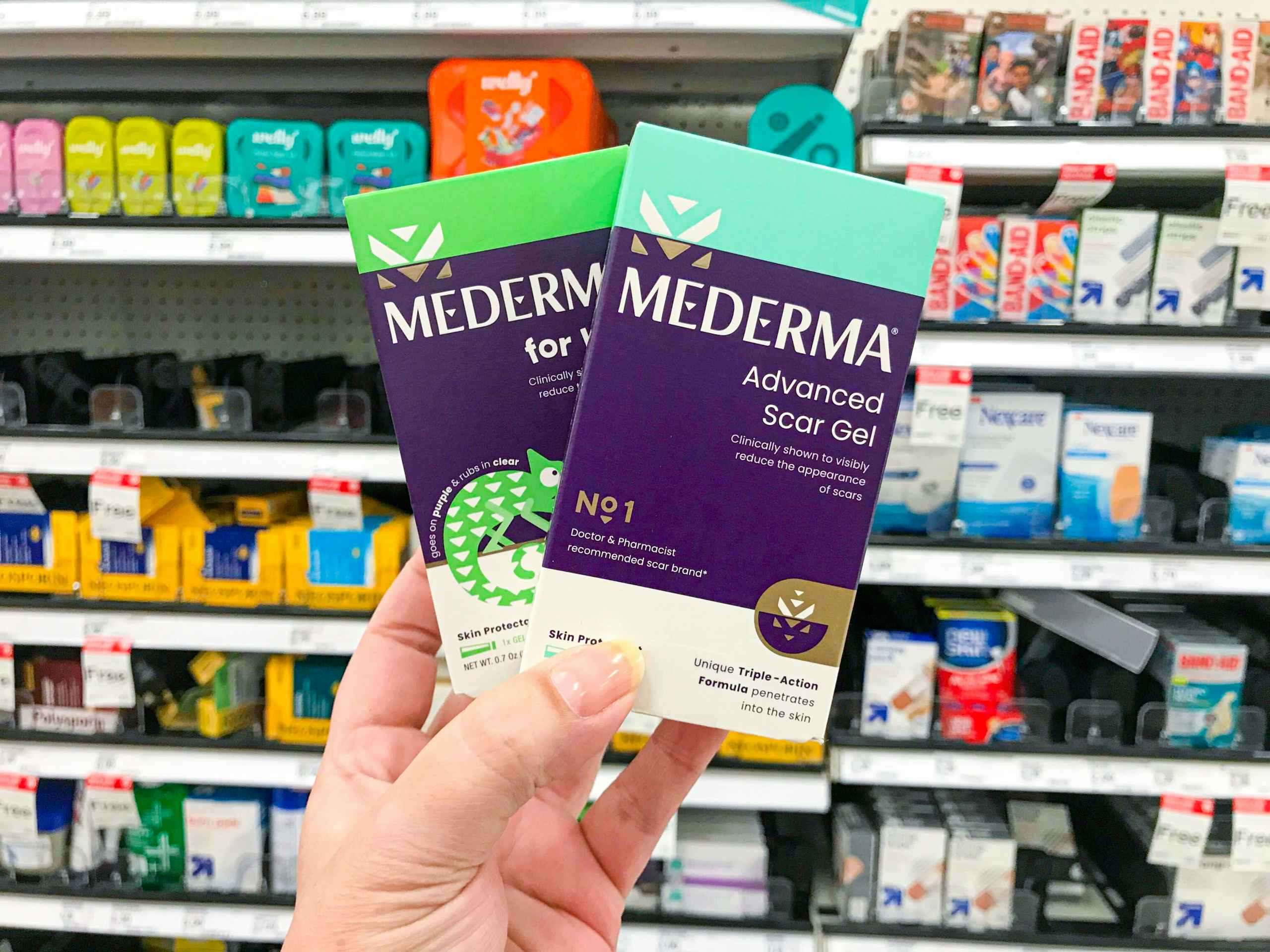 Mederma scar repair products with hand holding in front of Target shelf