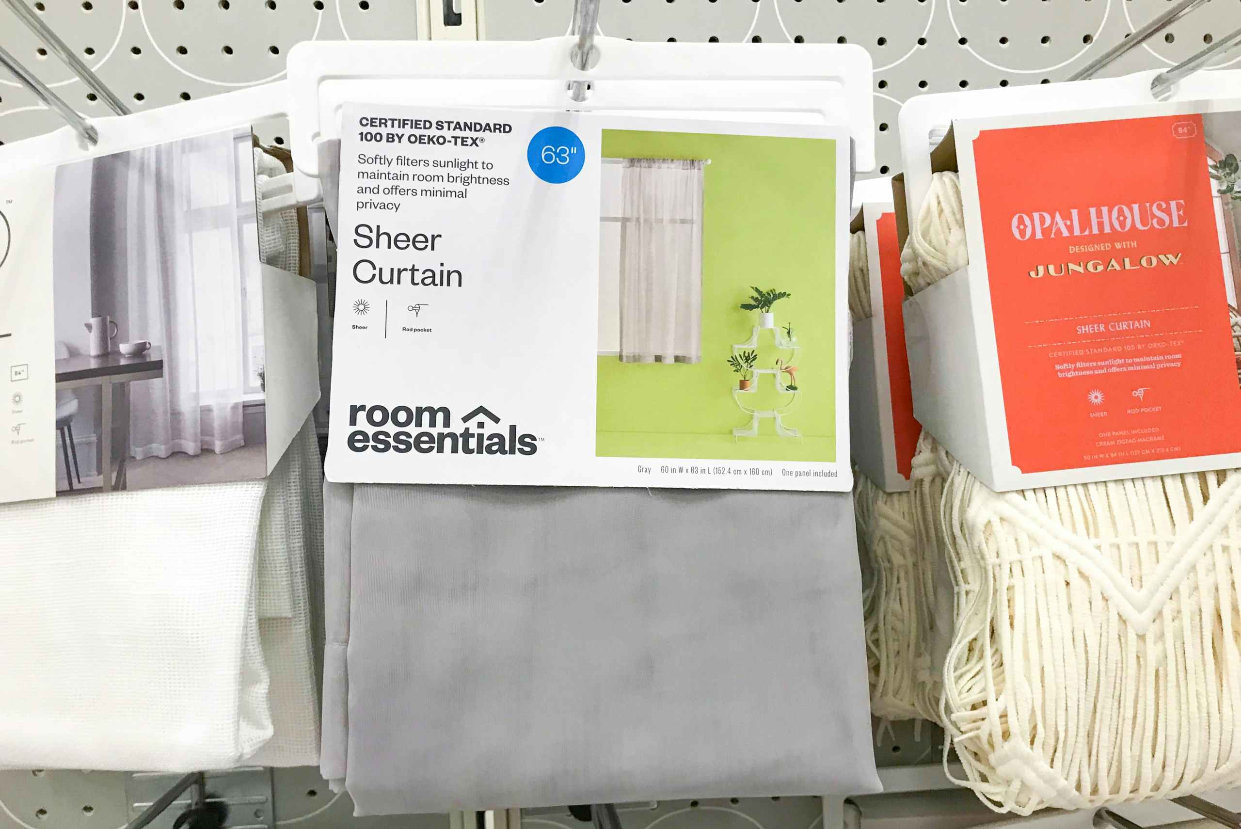 gray Room Essentials sheer curtains on a Target shelf
