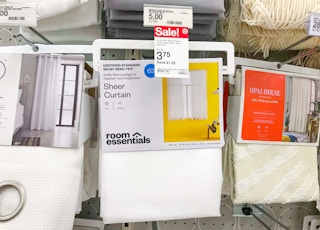 white Room Essentials sheer curtains on a Target shelf with sale price tag showing