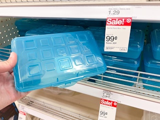 hand holding a blue Sterilite pencil box in front of a Target shelf with other pencil boxes and 99 cent sale price tag