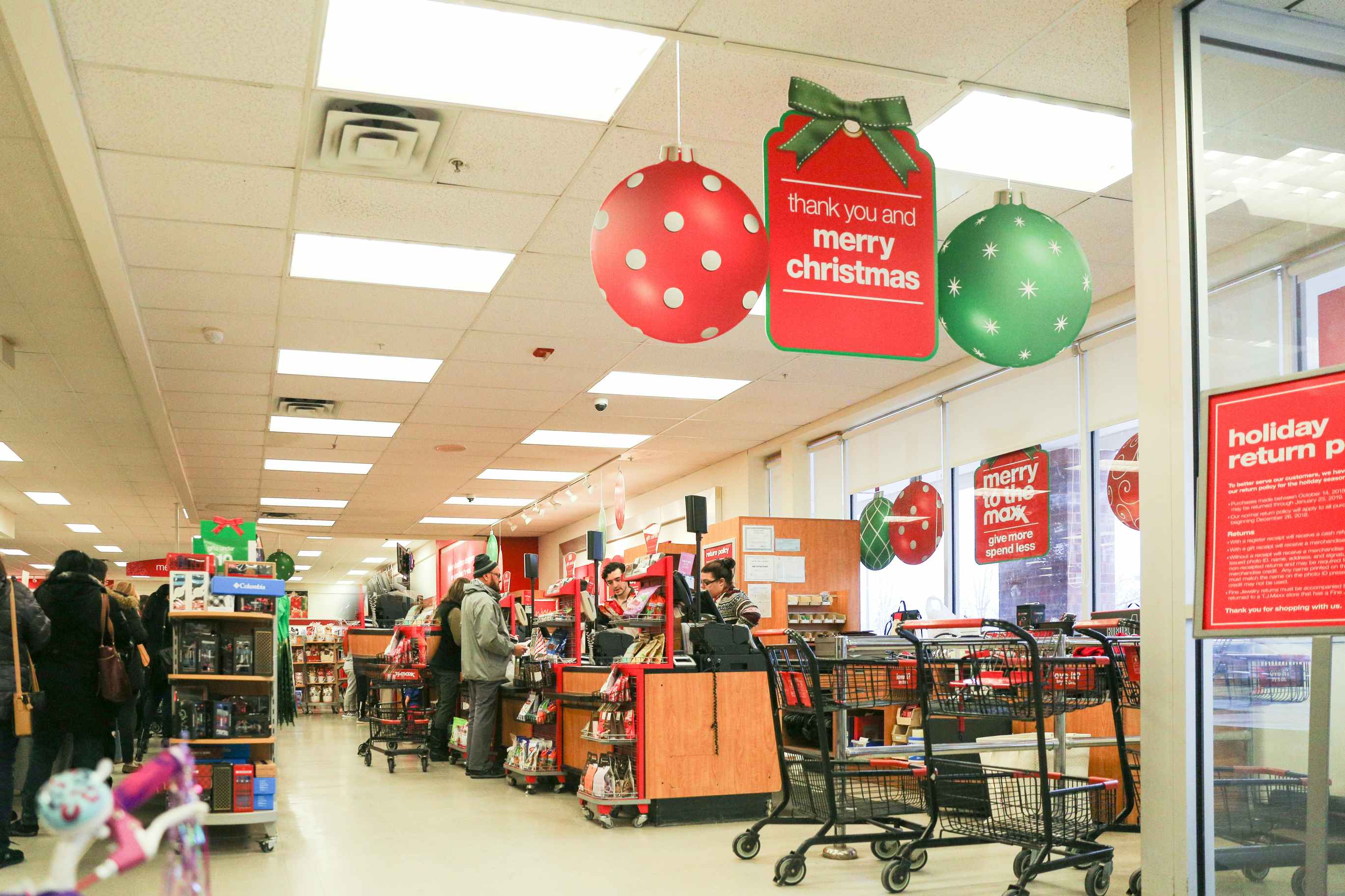 the checkout area inside a T.J. Maxx store with a sign that says Merry Christmas