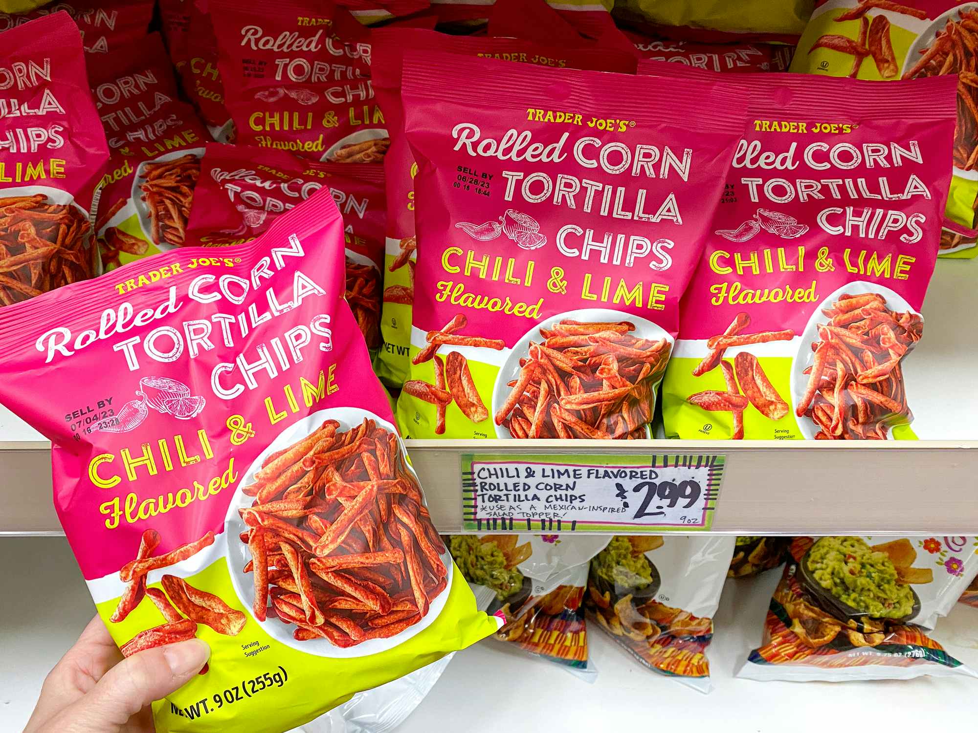 trader joes chili and lime-flavored rolled corn tortilla chips on store shelf