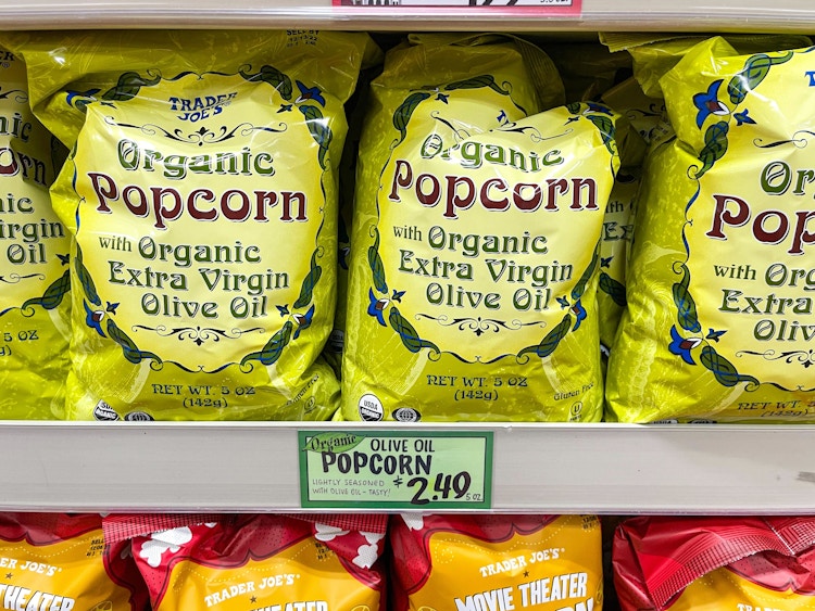 A shelf of Trader Joe's Organic Olive Oil Popcorn at Trader Joe's.