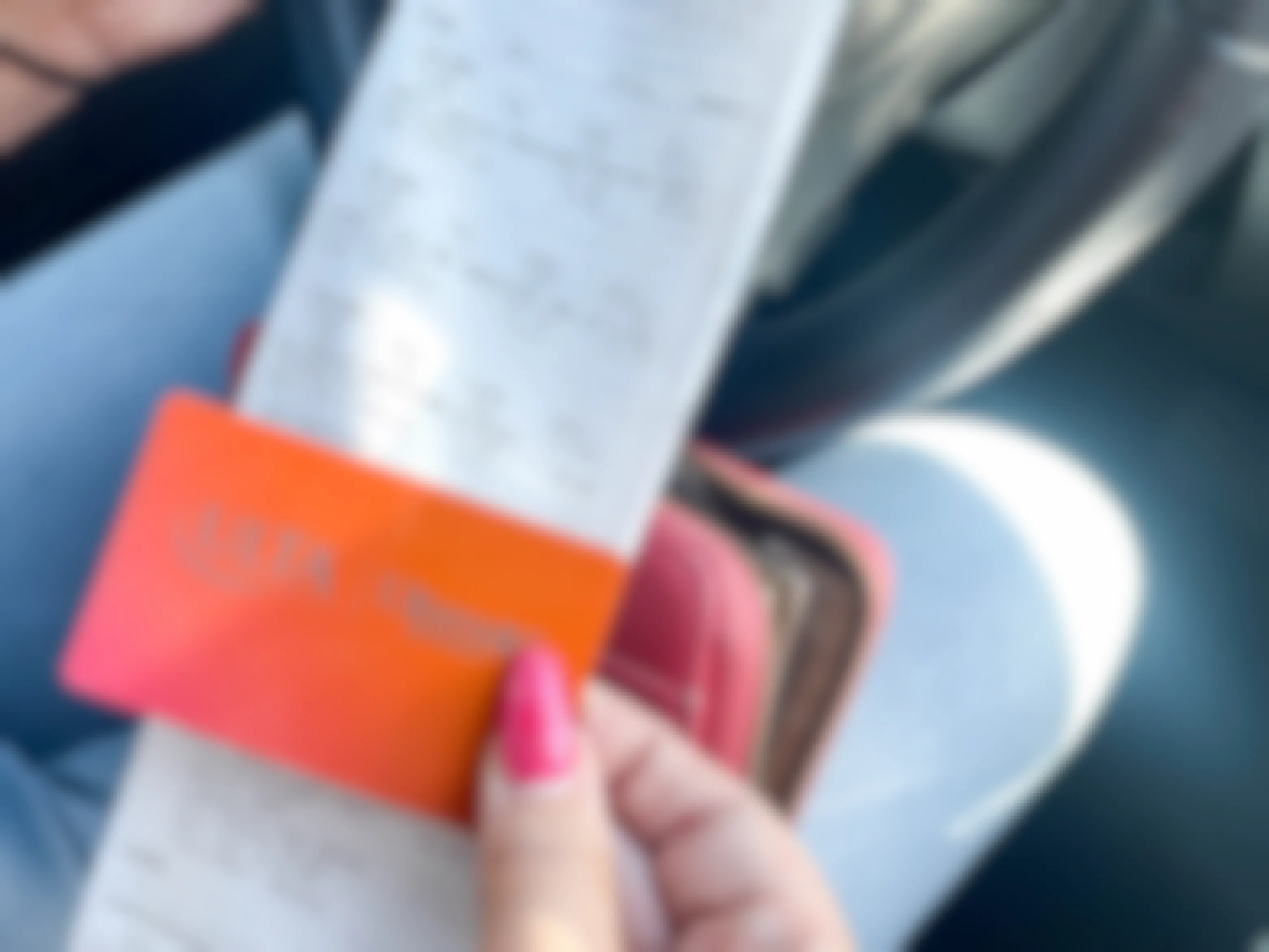 woman holding a receipt and ulta credit card